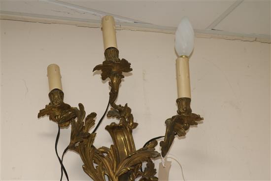 A pair of three branch ormolu wall lights length 55cm